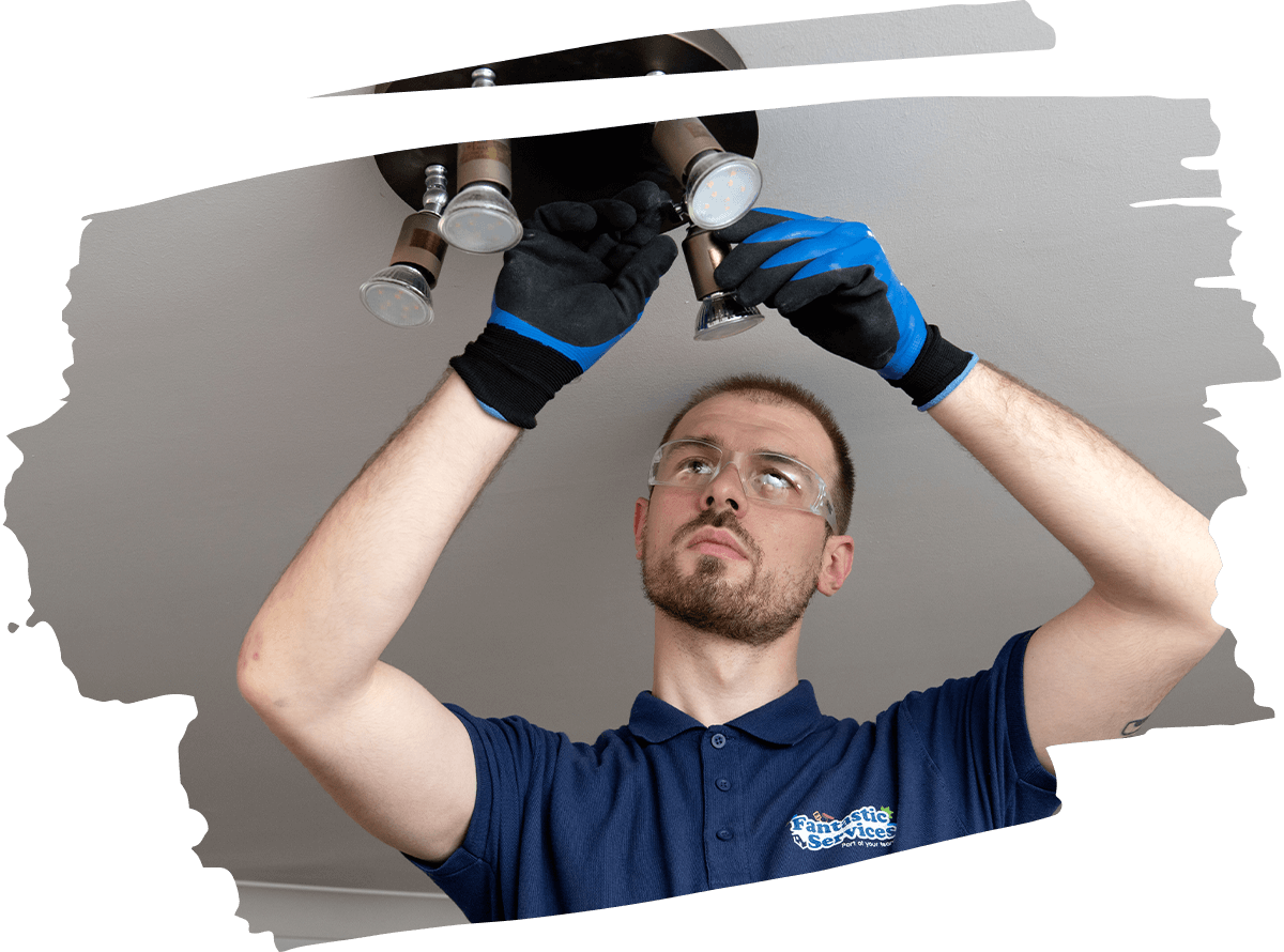 Picture of professional electrician who is fixing light fixture